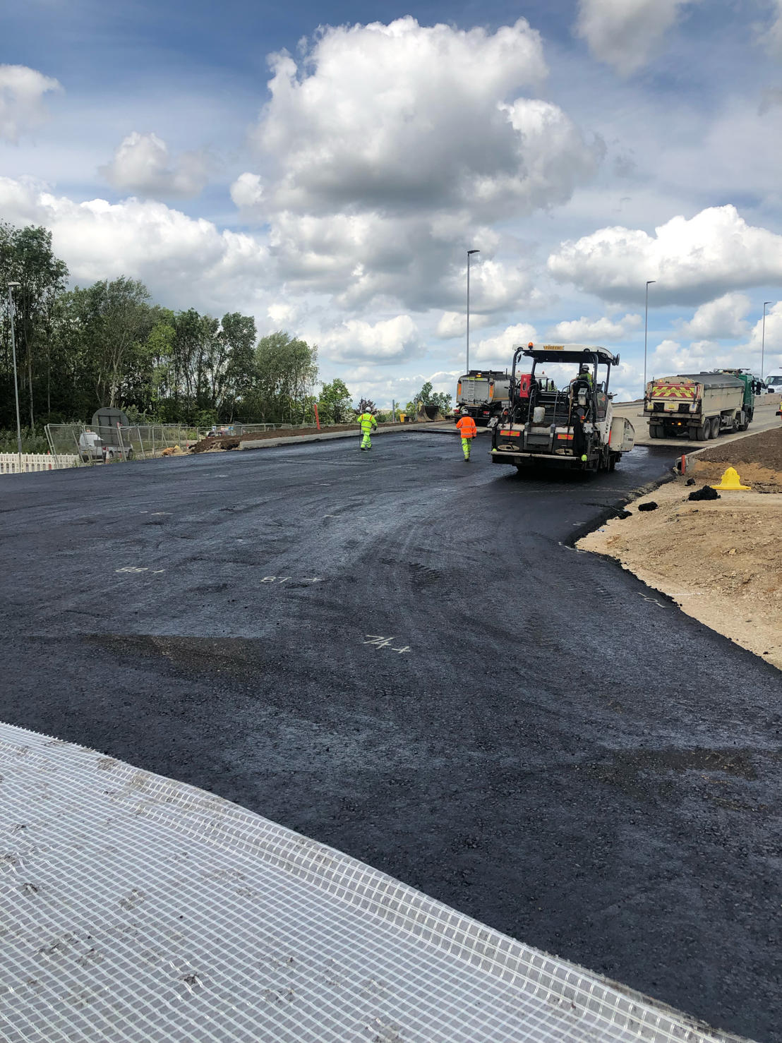 Road construction crew laying asphalt on a UK motorway scheme